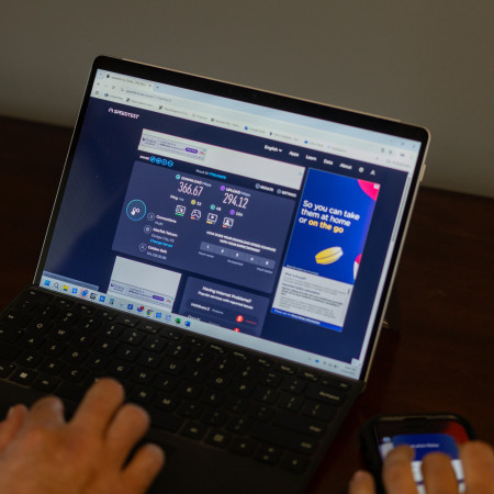 Laptop with screen open to speed test.