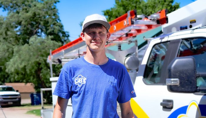 GBT Tech Jadon in front of his truck.